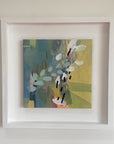 Framed abstract painting with a white border on a light gray wall
