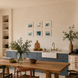 SIX MINI ART PRINTS IN BLUE ON WALL