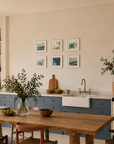 SIX MINI ART PRINTS IN BLUE ON WALL