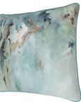A digital mockup of a square decorative throw pillow with an abstract watercolor design in shades of teal, blue, beige, and brown, shown on a website design canvas with a color selection form on the right.