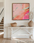 hot pink and blush canvas art on wall in hallway