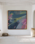 abstract blue artwork in oak frame on white wall